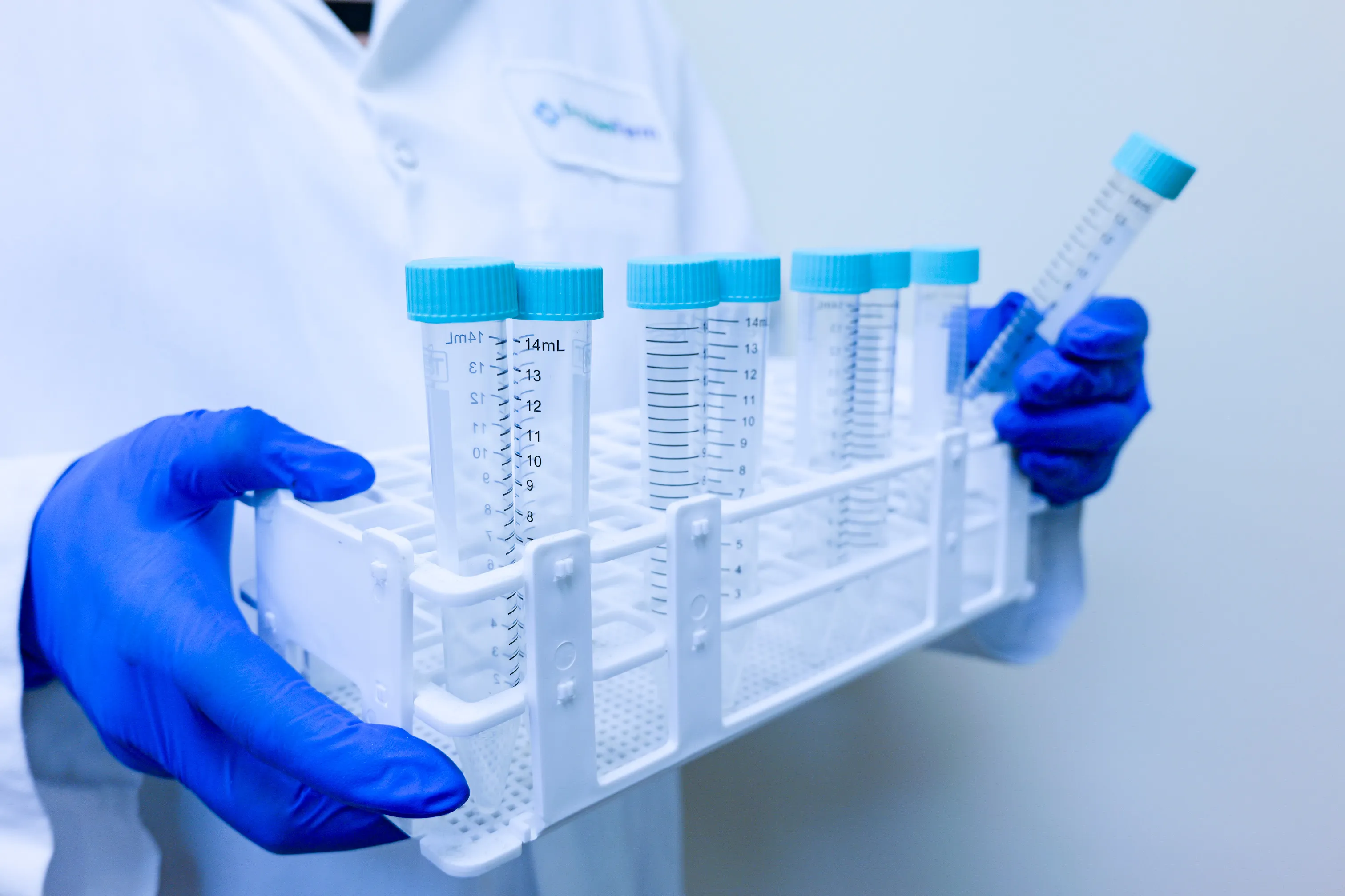 Lab technician holding test tubes for quality assurance